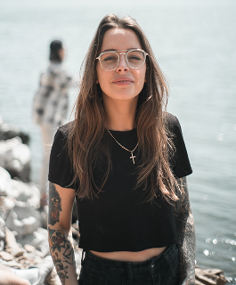 Jessica standing by a rocky shore