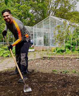 Paul shoveling dirt in his garden